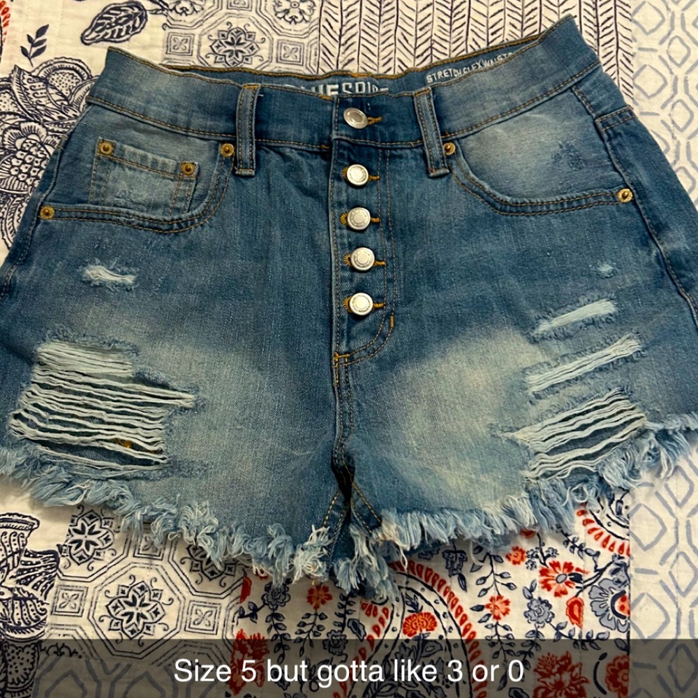 Ripped blue jean shorts